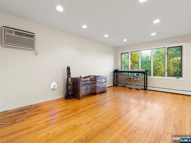 miscellaneous room featuring wood-type flooring, recessed lighting, a wall mounted AC, and baseboard heating