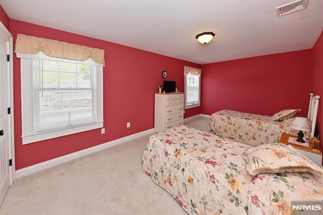 bedroom with visible vents, carpet flooring, baseboards, and multiple windows