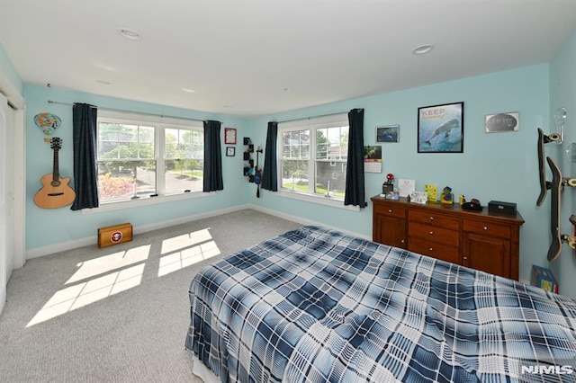 bedroom featuring baseboards and carpet