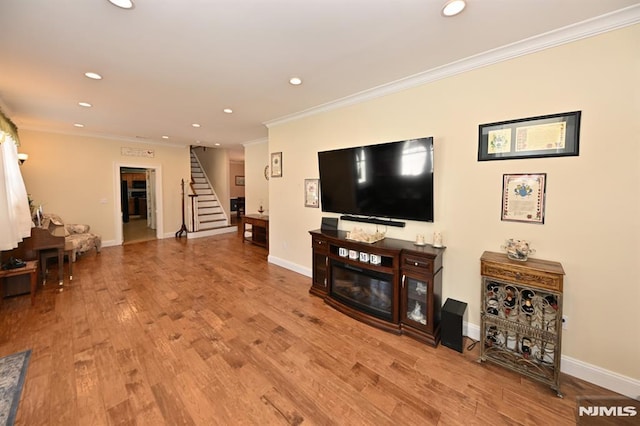 living room with recessed lighting and ornamental molding