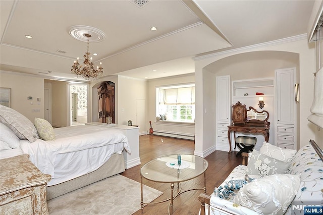 bedroom with arched walkways, a baseboard heating unit, dark wood-type flooring, a tray ceiling, and ornamental molding