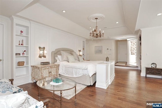 bedroom with hardwood / wood-style floors, a chandelier, recessed lighting, ornamental molding, and baseboards