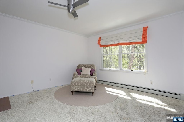 sitting room featuring a baseboard heating unit, ornamental molding, a ceiling fan, and carpet