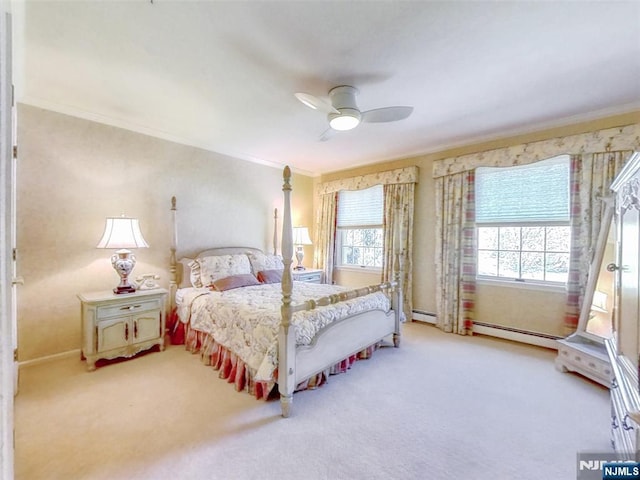 carpeted bedroom featuring ornamental molding, baseboard heating, and ceiling fan
