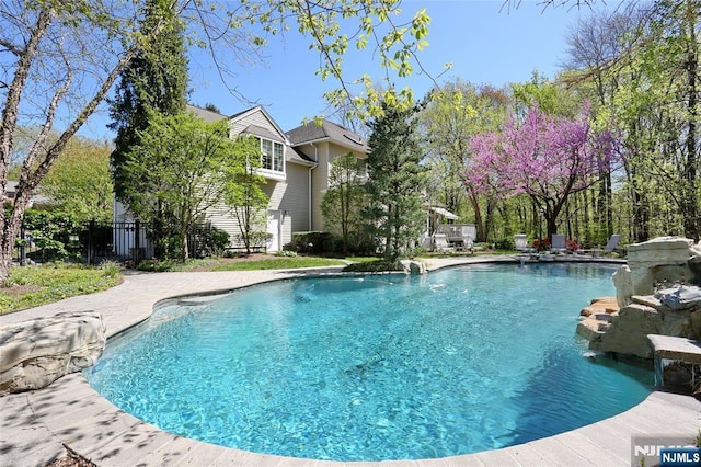 view of pool with fence