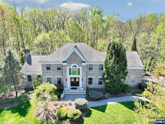 view of front of house with a front lawn and a chimney