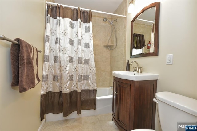 bathroom featuring toilet, shower / bathtub combination with curtain, and vanity
