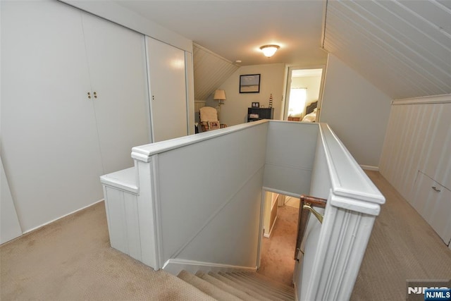 stairs with carpet floors and lofted ceiling