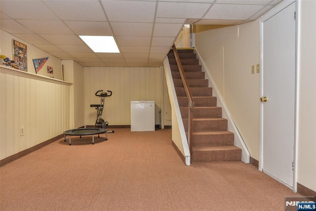 interior space featuring stairway, baseboards, light carpet, and a paneled ceiling