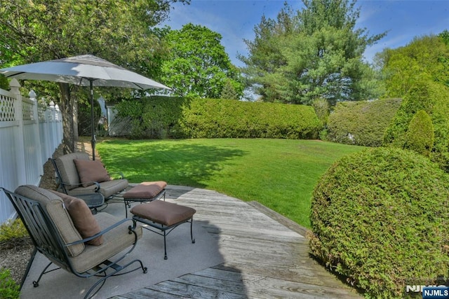view of yard with fence and a deck