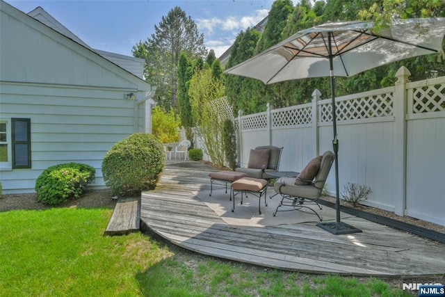 deck featuring a lawn and fence