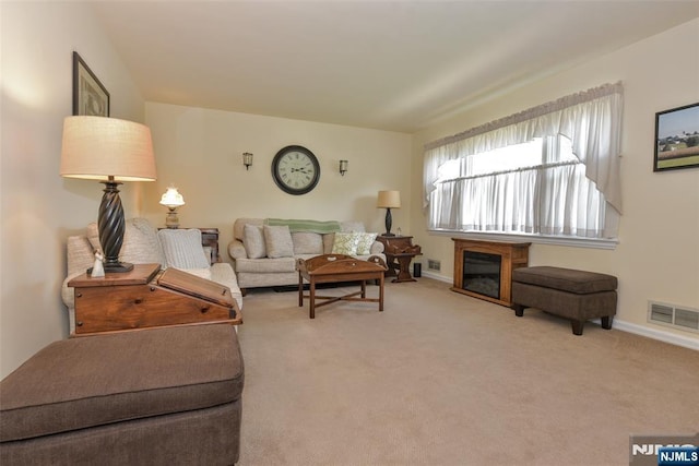 carpeted living room featuring baseboards and visible vents