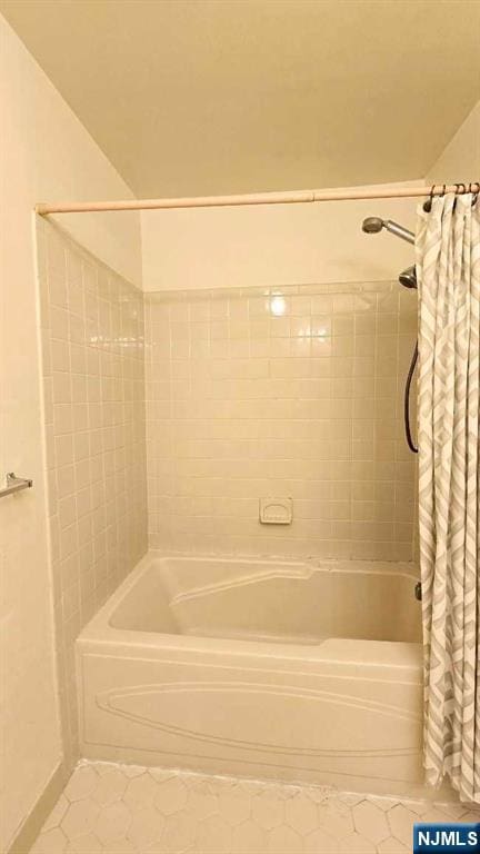 bathroom featuring tile patterned floors and shower / bathtub combination with curtain