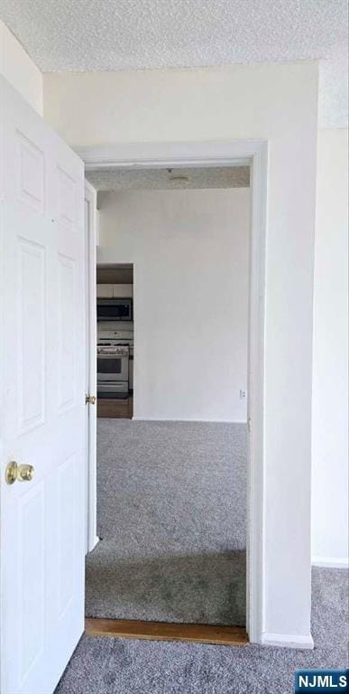 hall with a textured ceiling