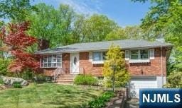 single story home with a garage and a front lawn