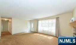 unfurnished living room featuring carpet and a fireplace