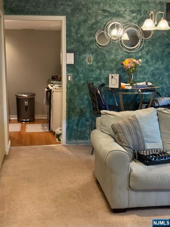 interior space with an inviting chandelier, baseboards, and wallpapered walls