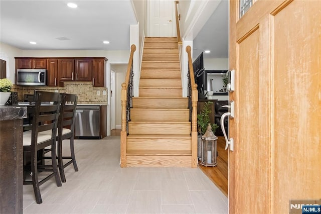 staircase featuring recessed lighting