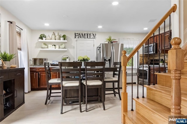 dining room featuring stairway and recessed lighting