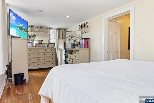 bedroom featuring hardwood / wood-style floors and recessed lighting