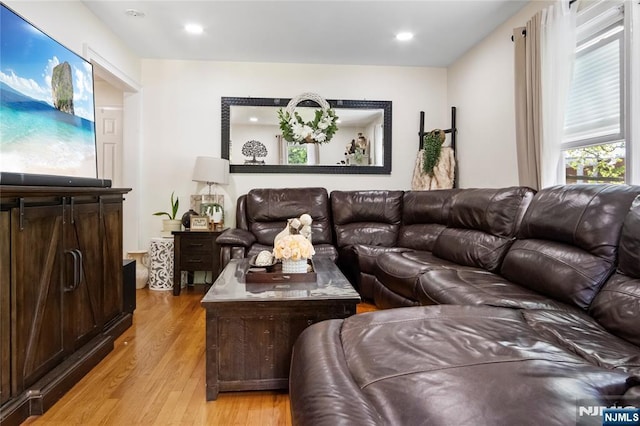 living area with light wood finished floors and recessed lighting