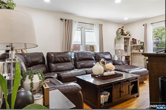 living room featuring light wood-style flooring and recessed lighting