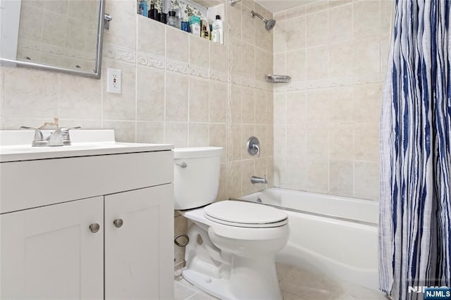 full bathroom with shower / bath combo, tile walls, toilet, vanity, and tile patterned floors