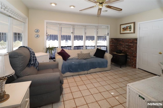 living area featuring ceiling fan and light tile patterned flooring