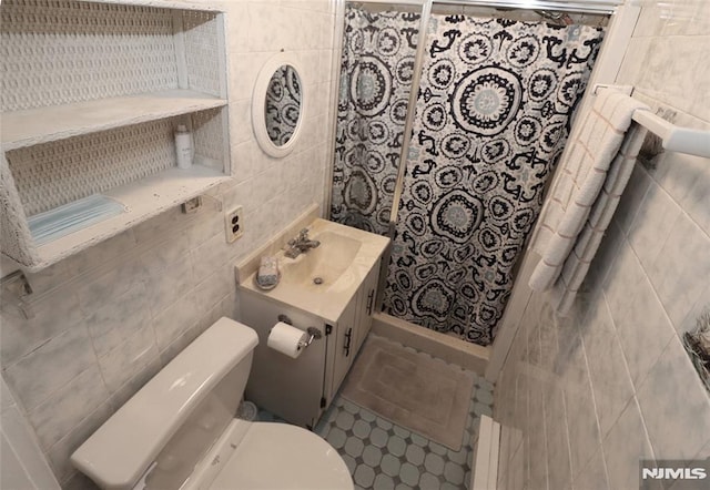 bathroom featuring tile walls, vanity, and toilet