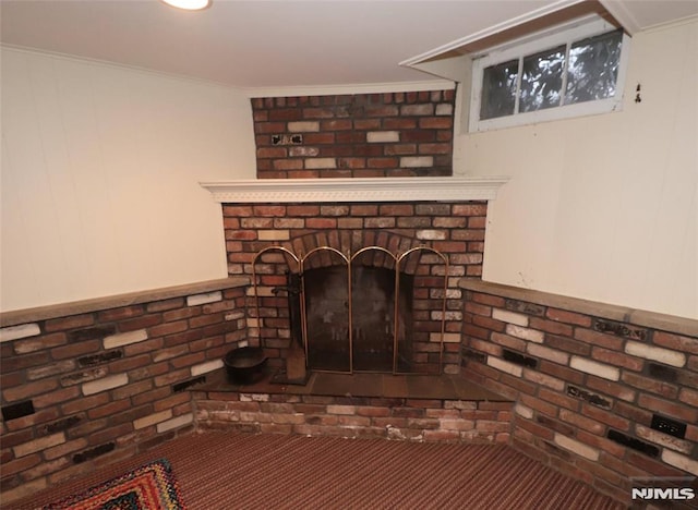 details with ornamental molding and a brick fireplace