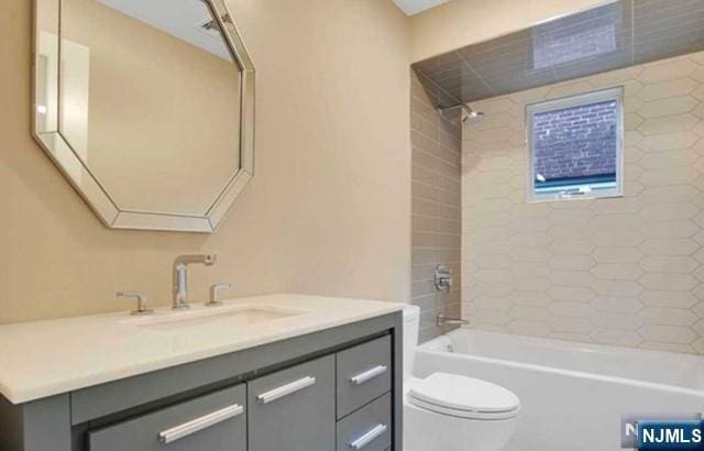 full bathroom featuring vanity, tub / shower combination, and toilet