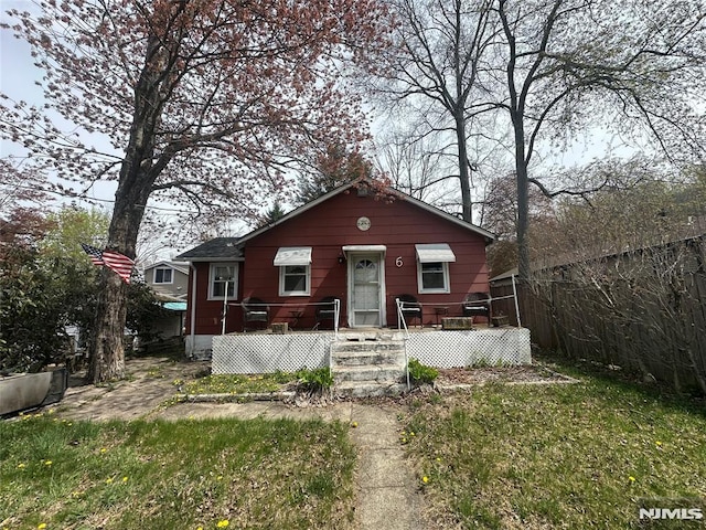 bungalow-style home featuring a fenced front yard
