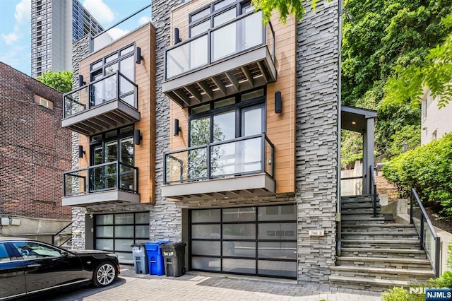 746B Undercliff Unit B, Edgewater, NJ 07020 - view of front of property with a balcony, a garage, decorative driveway, and stone siding