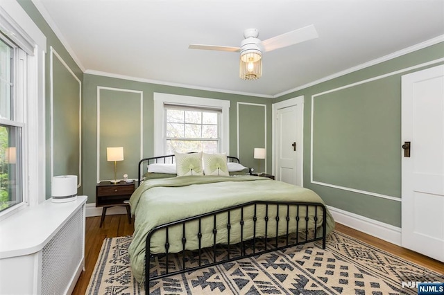 bedroom featuring baseboards, ornamental molding, and wood finished floors