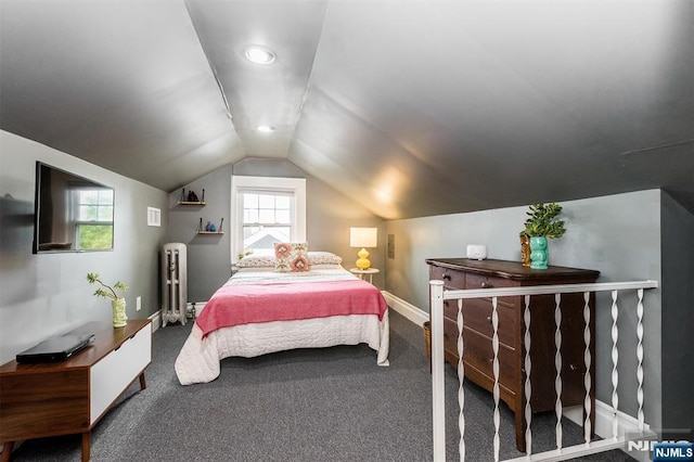 bedroom featuring baseboards, carpet, radiator heating unit, and vaulted ceiling