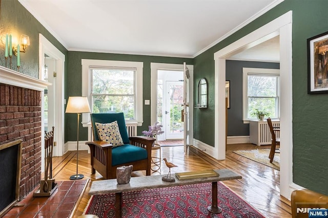 sitting room with crown molding, baseboards, and wood finished floors