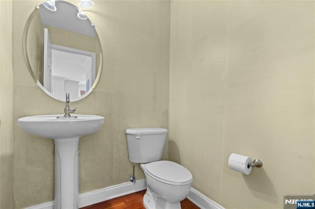 202 Blue Heron Dr, Secaucus, NJ 07094 - bathroom with toilet, baseboards, and wood finished floors