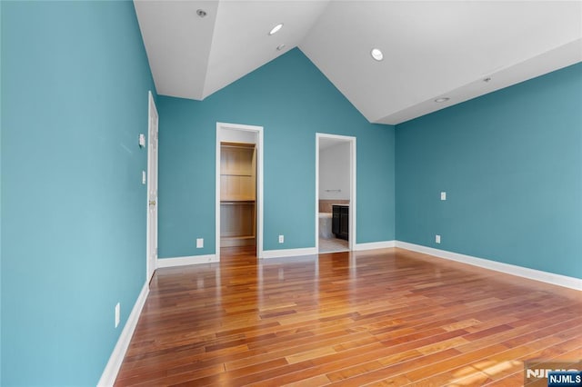 202 Blue Heron Dr, Secaucus, NJ 07094 - unfurnished bedroom with baseboards, a walk in closet, light wood finished floors, and a closet