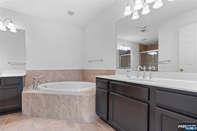 202 Blue Heron Dr, Secaucus, NJ 07094 - bathroom with a garden tub, a stall shower, two vanities, a sink, and a notable chandelier