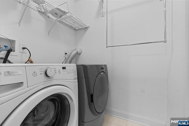 202 Blue Heron Dr, Secaucus, NJ 07094 - clothes washing area with laundry area, baseboards, light tile patterned floors, and washing machine and clothes dryer