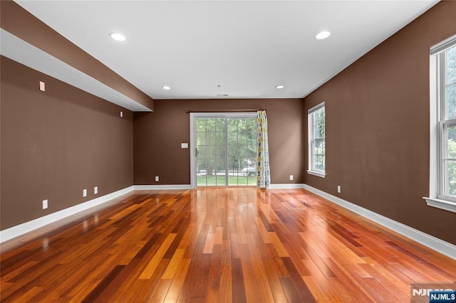 202 Blue Heron Dr, Secaucus, NJ 07094 - unfurnished living room with plenty of natural light, baseboards, and hardwood / wood-style floors