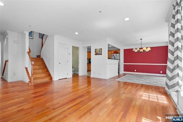 202 Blue Heron Dr, Secaucus, NJ 07094 - unfurnished living room with ornamental molding, light wood-style flooring, and a chandelier