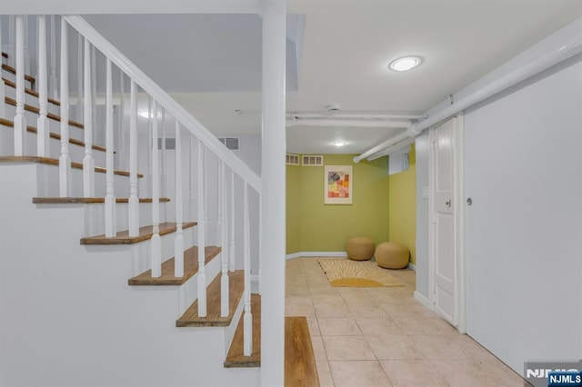 stairs featuring tile patterned flooring and visible vents
