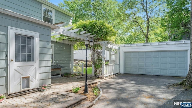 view of side of home with a pergola and a garage