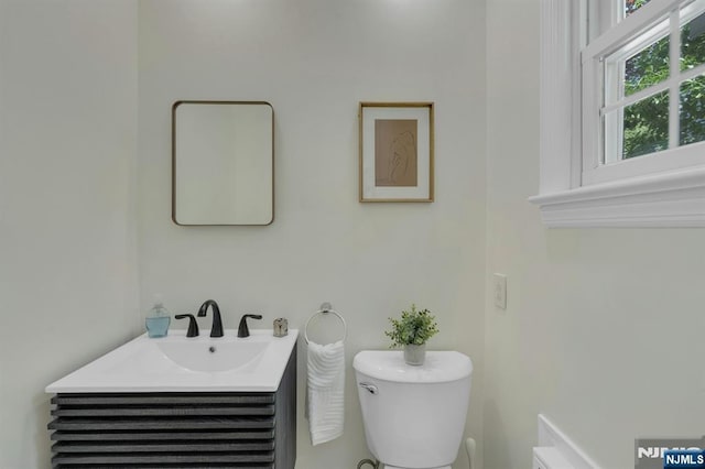bathroom with toilet and vanity