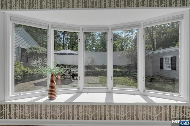 unfurnished sunroom featuring wallpapered walls