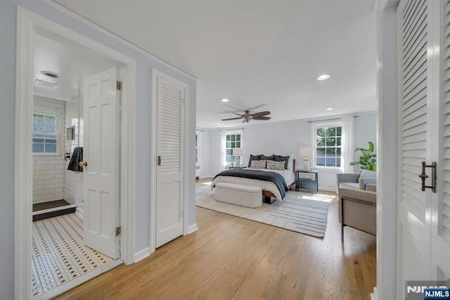 bedroom featuring baseboards, light wood-style flooring, and recessed lighting