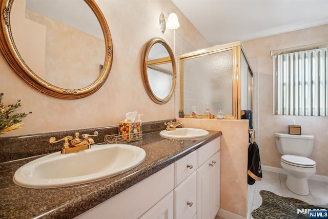 full bath with a sink, tile patterned floors, toilet, and a shower stall