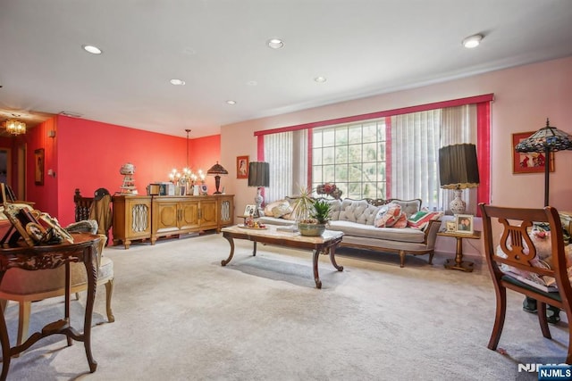 living room with light carpet, recessed lighting, and a notable chandelier