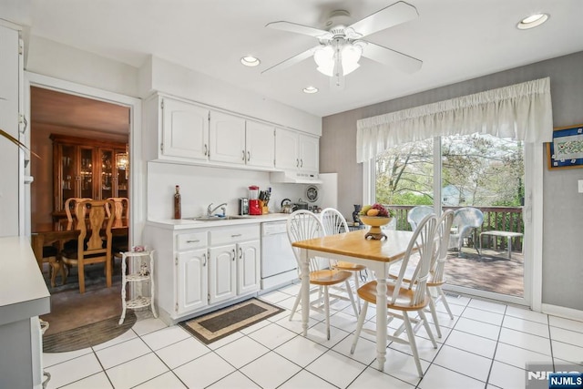 kitchen featuring a ceiling fan, dishwasher, a sink, light countertops, and white cabinets
